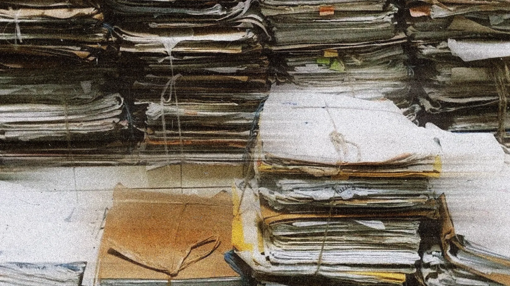 Stack of weathered paper medical folders and files