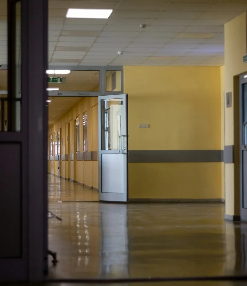 Blurred yellow-walled hospital hallway