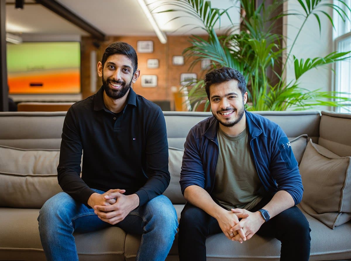 Our two co-founders, Abdel and Zahid, sat on a sofa.